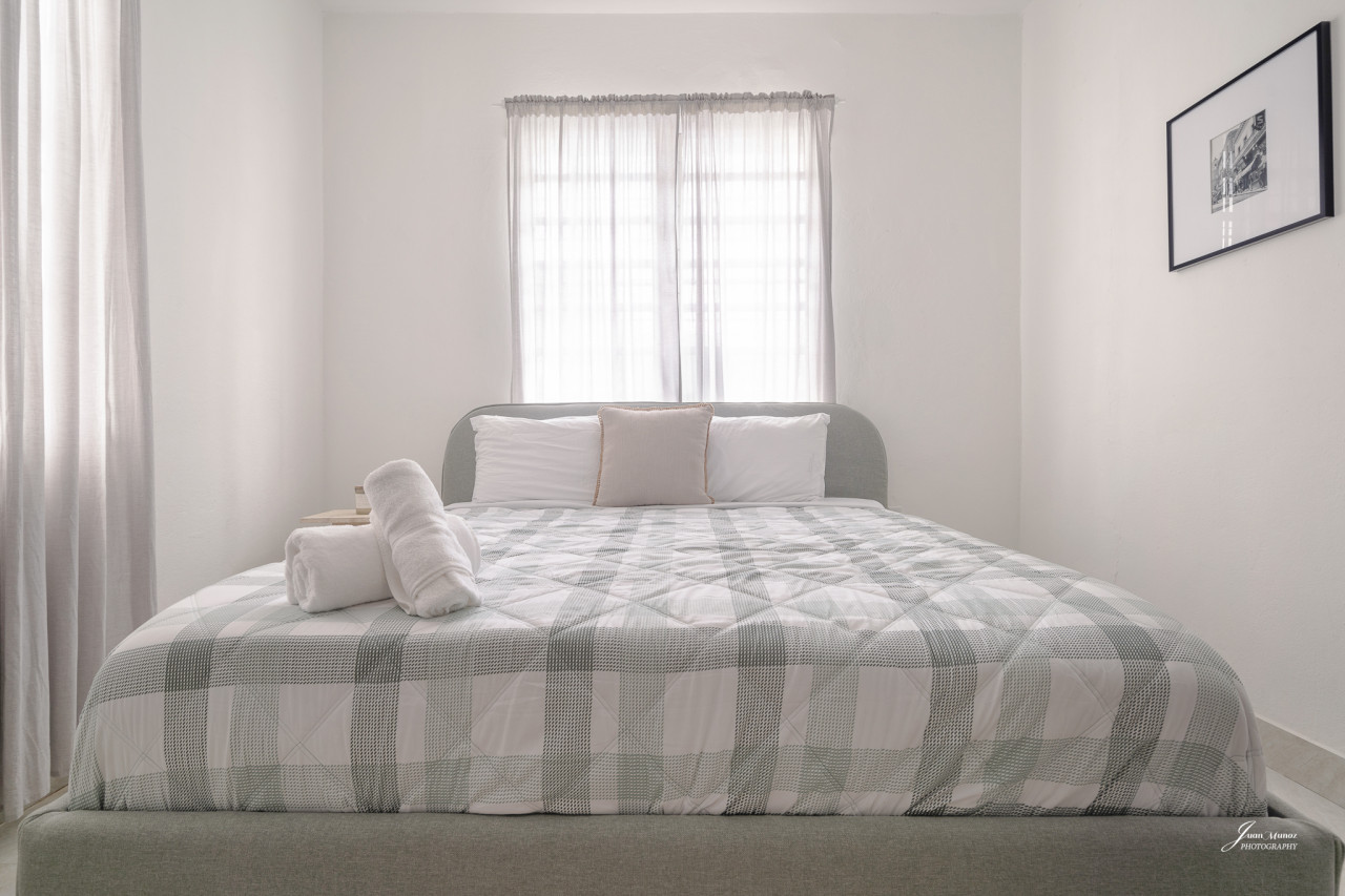 Bedroom with a bed and a window — Villa Blanca | San Juan | La Plácita, Miramar