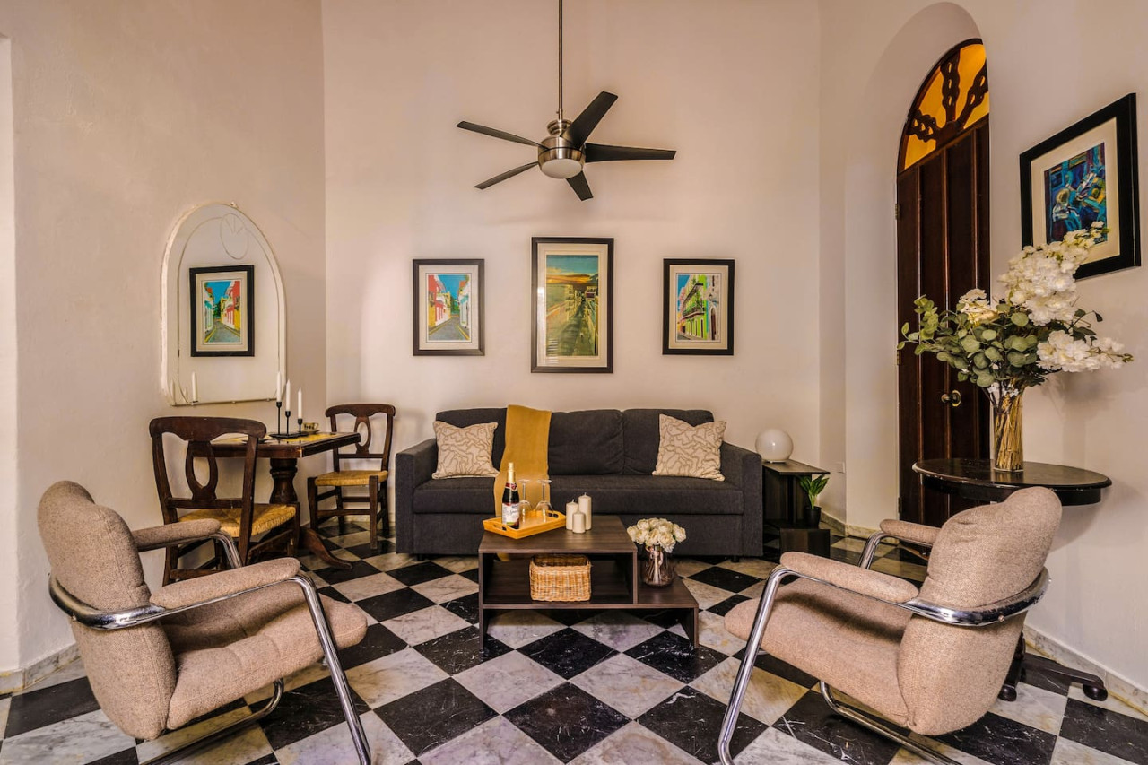Living room with a couch, chairs, and a ceiling fan — Ocean Breeze | Old San Juan | Spanish Style, Old San Juan