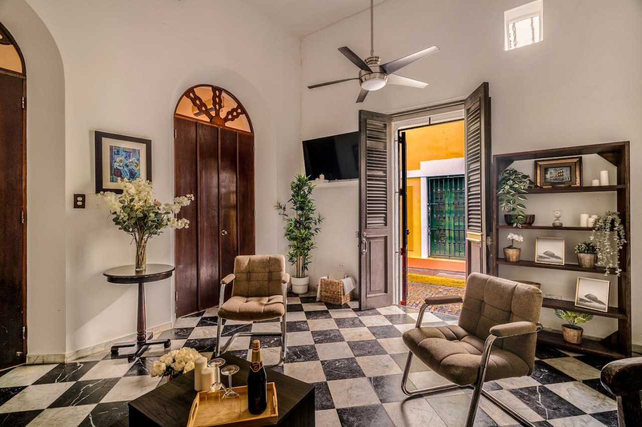 Living room with a couch and a TV — Ocean Breeze | Old San Juan | Spanish Style, Old San Juan