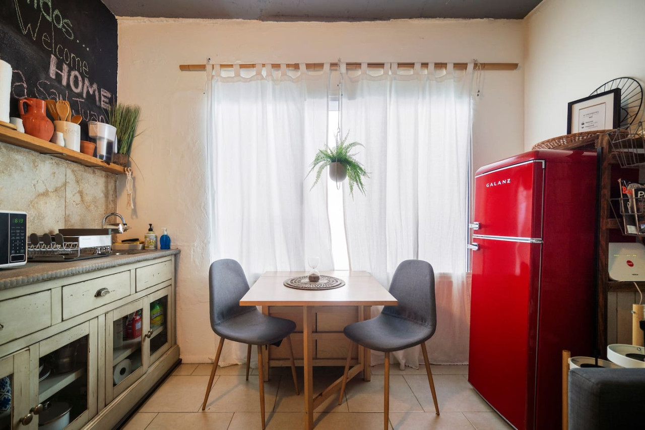 Dining table with two chairs in front of a window — Sunset Haven | Ocean Breeze | Old San Juan, Old San Juan