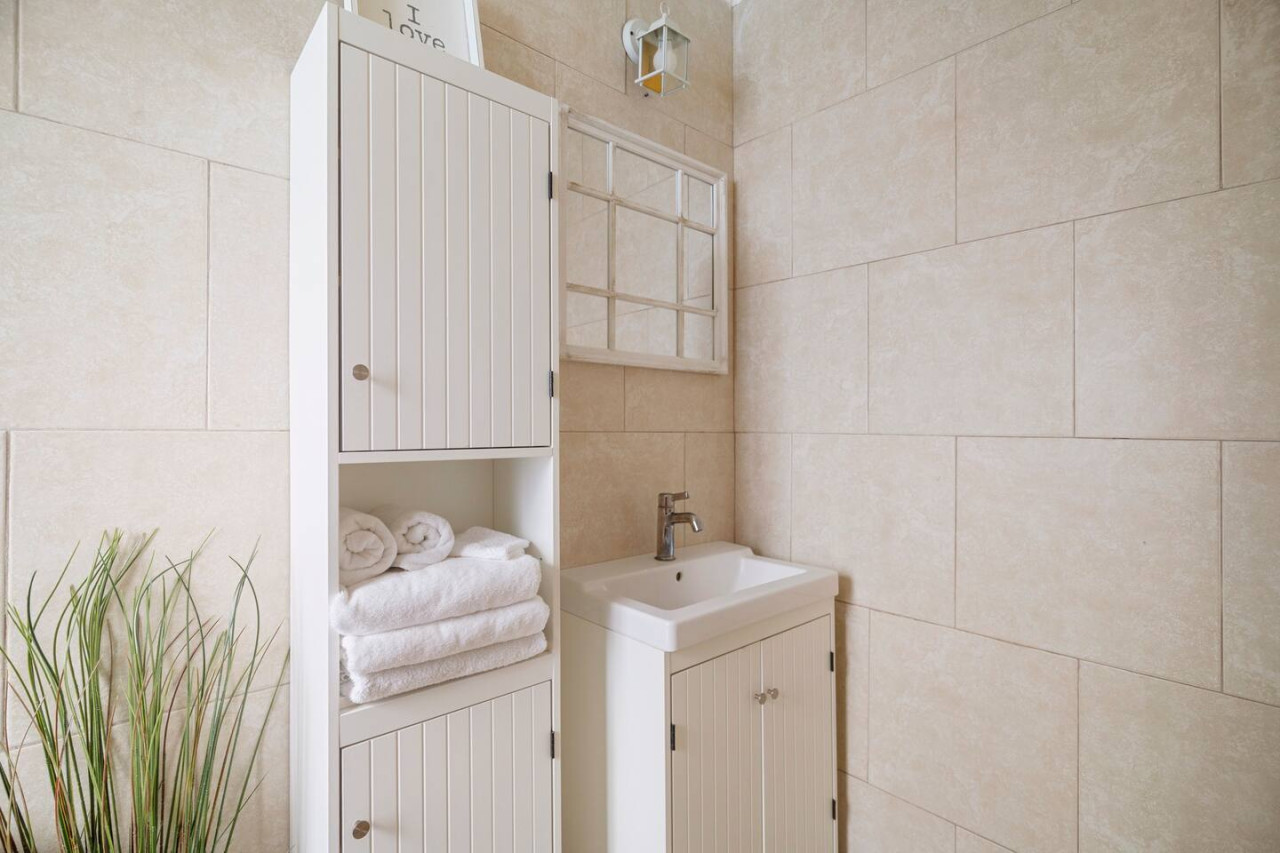 Bathroom with a sink and a mirror — Sunset Haven | Ocean Breeze | Old San Juan, Old San Juan