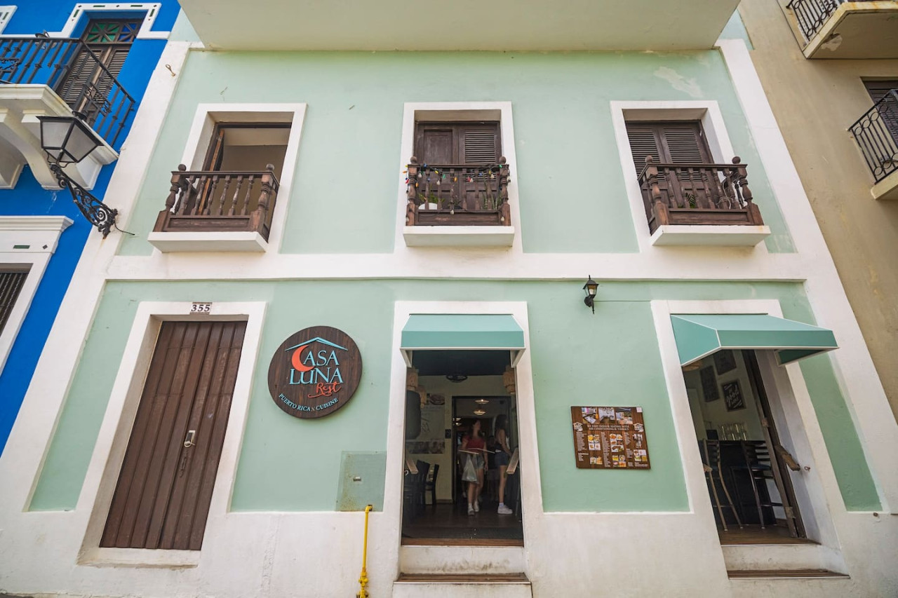 Green building with a balcony — Sunset Haven | Ocean Breeze | Old San Juan, Old San Juan