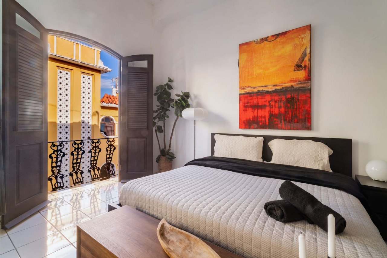 Bedroom with a bed and a potted plant — Spanish Penthouse Historic Mansion Private Patio, Old San Juan