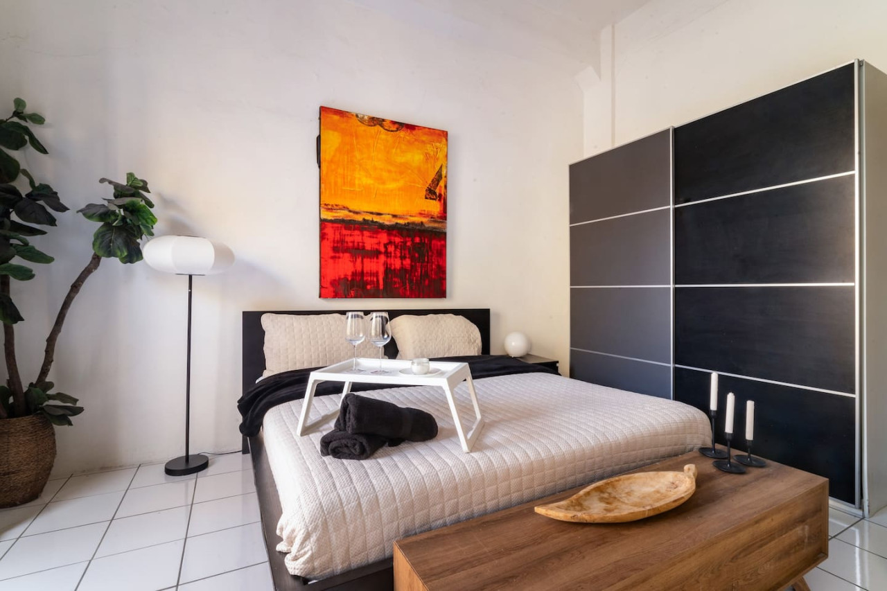 Bedroom with a bed, table, and painting on the wall — Spanish Penthouse Historic Mansion Private Patio, Old San Juan