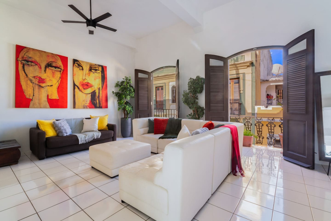 Living room with a white couch and a red blanket on it — Spanish Penthouse Historic Mansion Private Patio, Old San Juan
