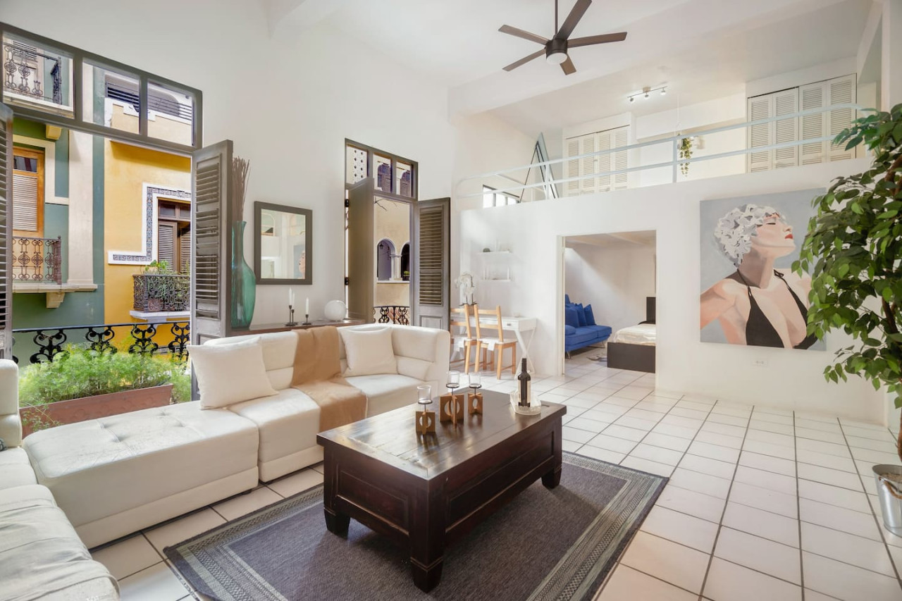 Living room with a couch and a table — Spanish Duplex | Private Patio | Walk to Ocean, Old San Juan