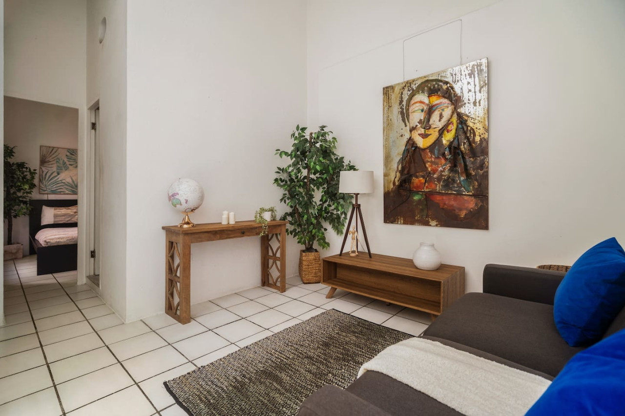 Bedroom with a bed and a painting on the wall (bedroom 2) — Spanish Duplex | Private Patio | Walk to Ocean, Old San Juan
