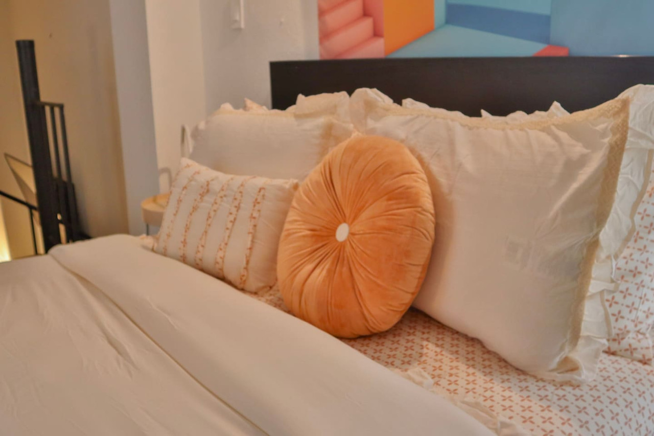 Bedroom with a white bedspread and pillows — Puerto Escape | Old San Juan, Old San Juan