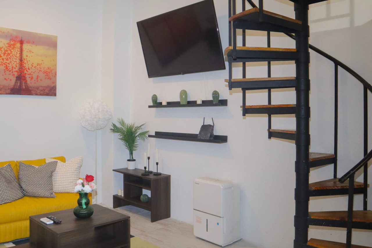 Living room with a flat screen TV on the wall — Puerto Escape | Old San Juan, Old San Juan
