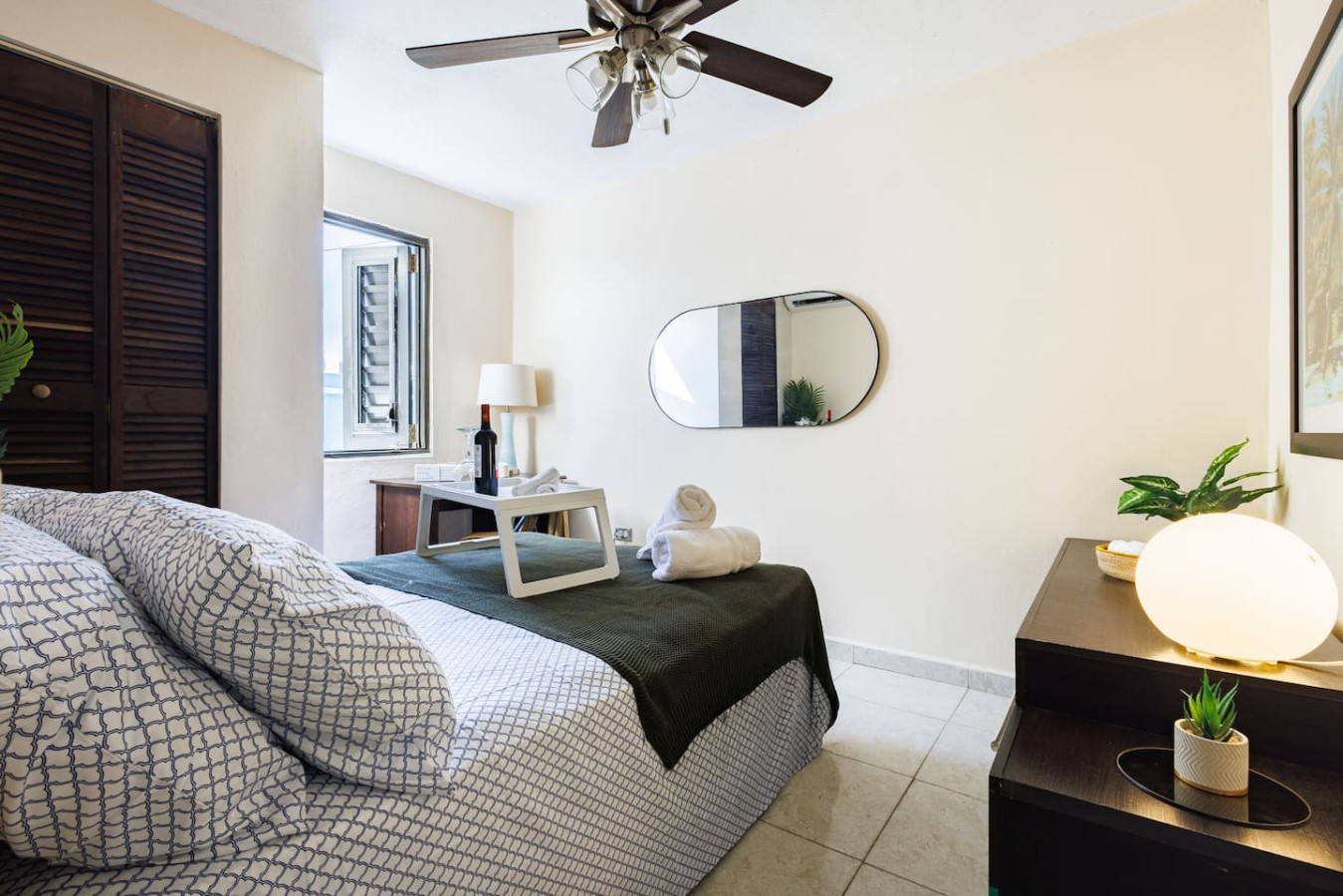 Bedroom with a bed, a chair, a table, and a mirror — Ocean Sol Historic Old San Juan, Old San Juan