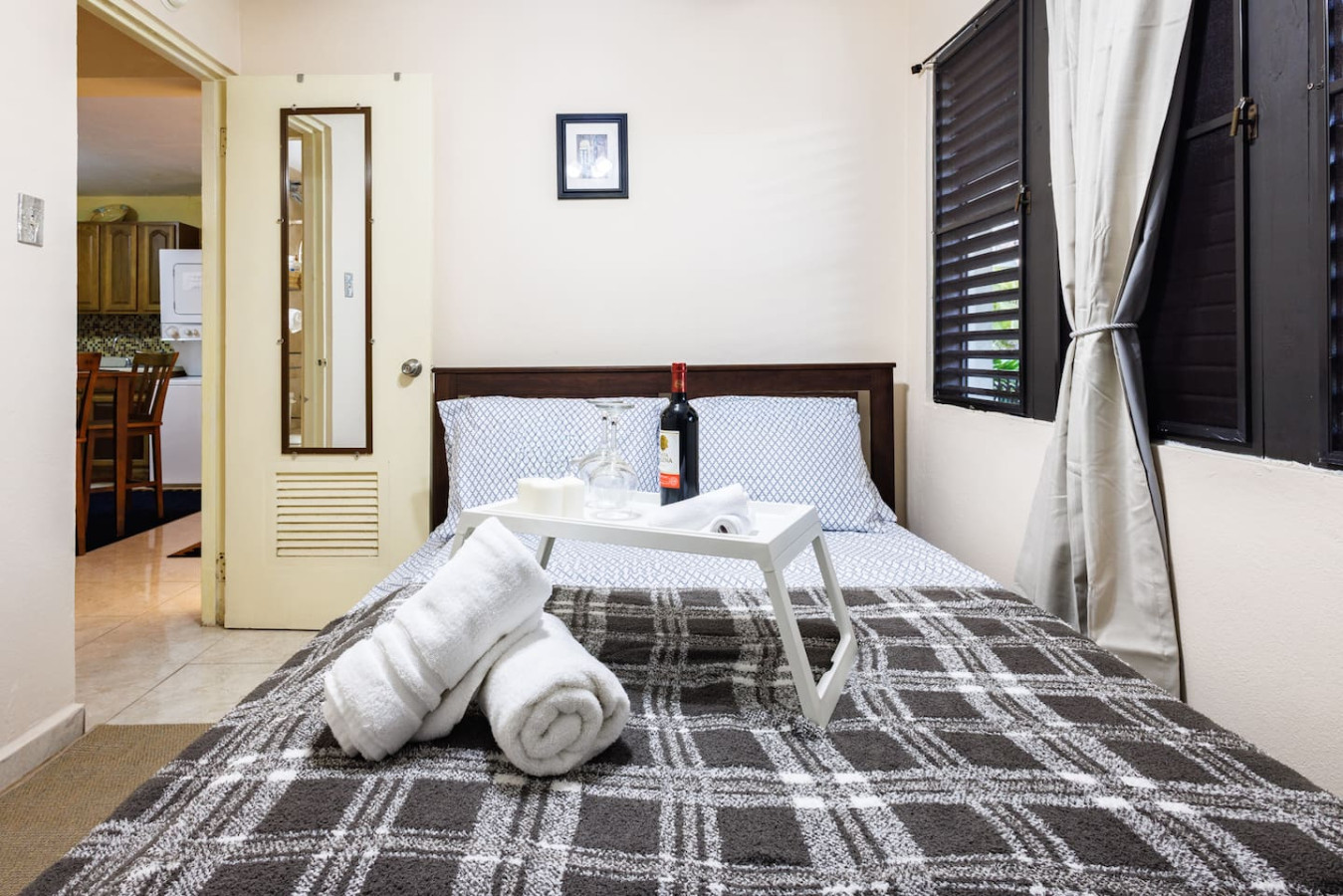 Bedroom with a bed, a table with a bottle of wine and a towel on it — Ocean Sol Historic Old San Juan, Old San Juan