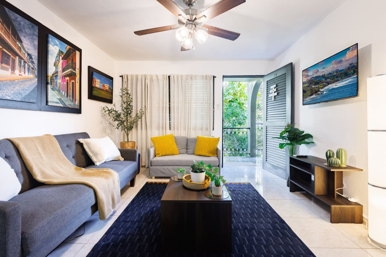 Living room with a couch, coffee table, and potted plants — Ocean Sol Historic Old San Juan, Old San Juan