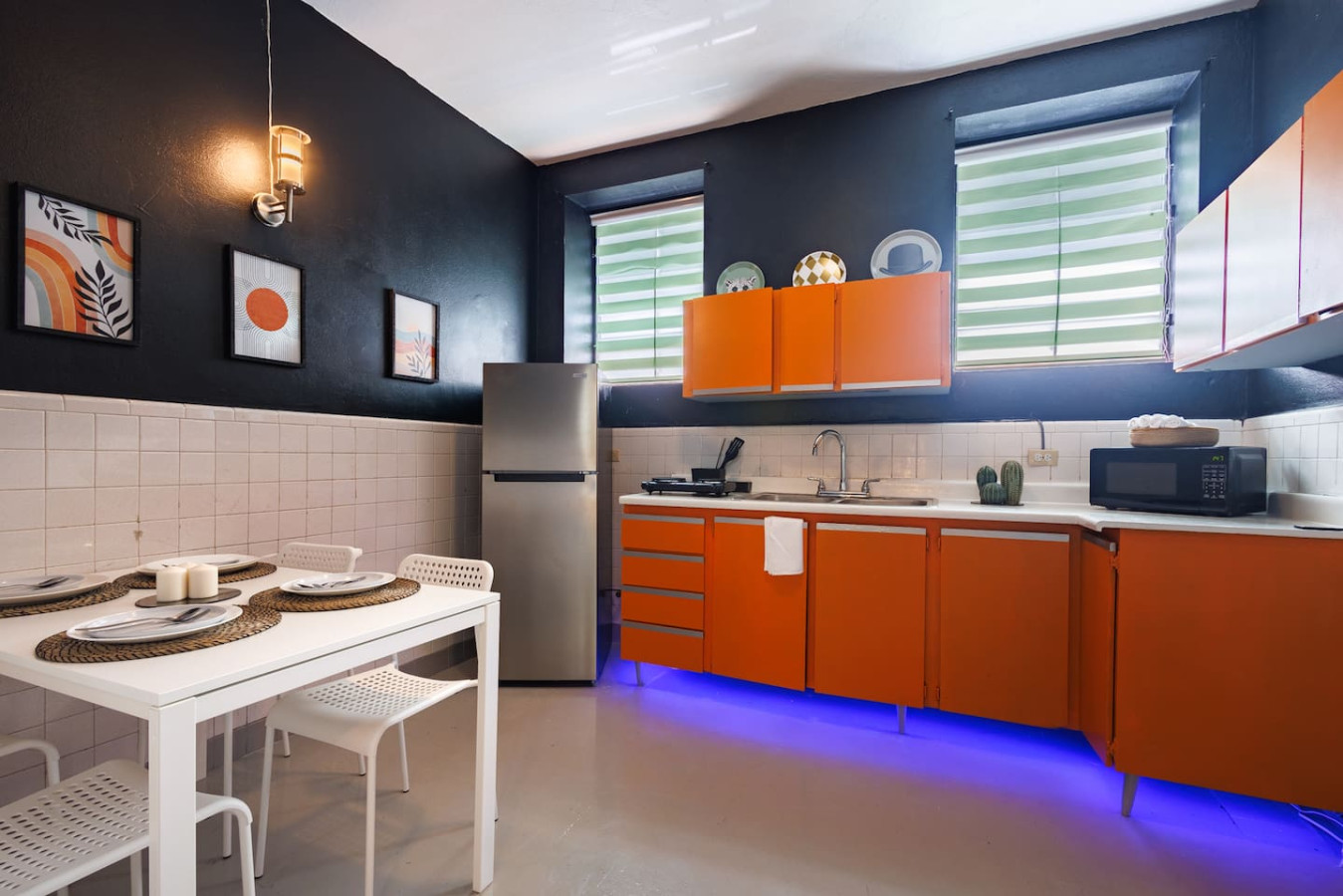 Kitchen with a refrigerator, sink, and orange cabinets — Spain Lagoon | San Juan | Private Patio, Santurce