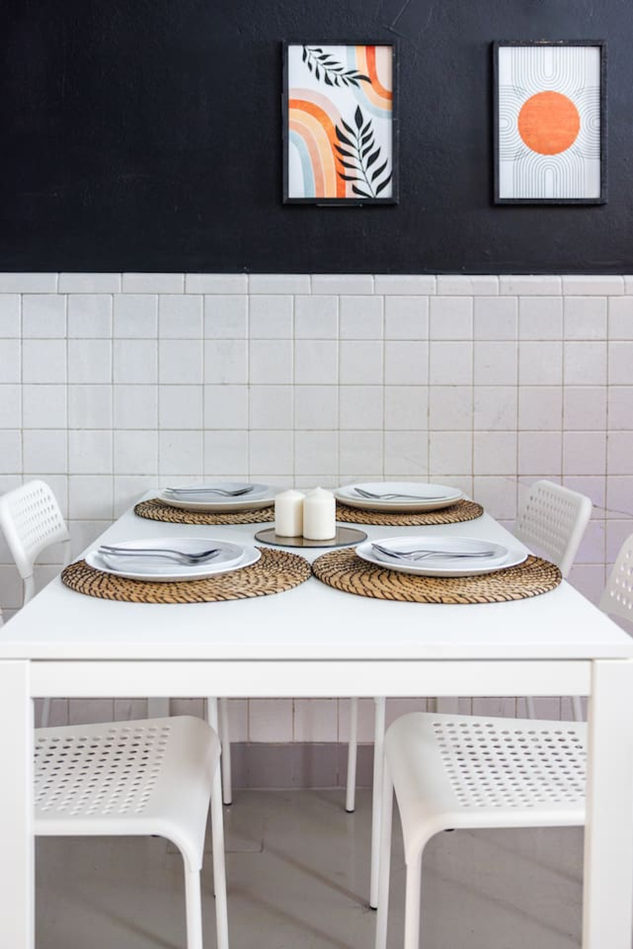 White dining table with a black and white tablecloth and place settings — Spain Lagoon | San Juan | Private Patio, Santurce