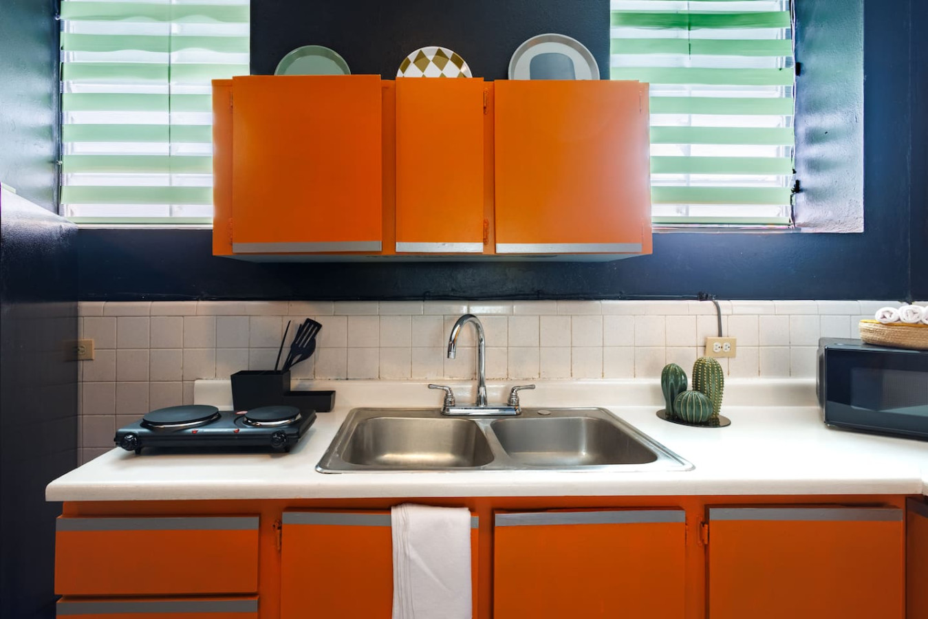 Kitchen with orange cabinets and a sink — Spain Lagoon | San Juan | Private Patio, Santurce