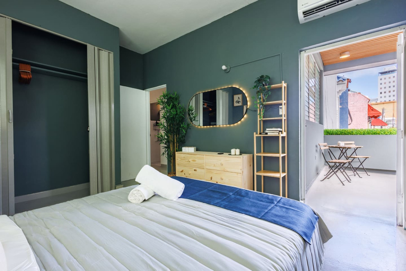 Bedroom with a bed and a mirror — Spain Lagoon | San Juan | Private Patio, Santurce