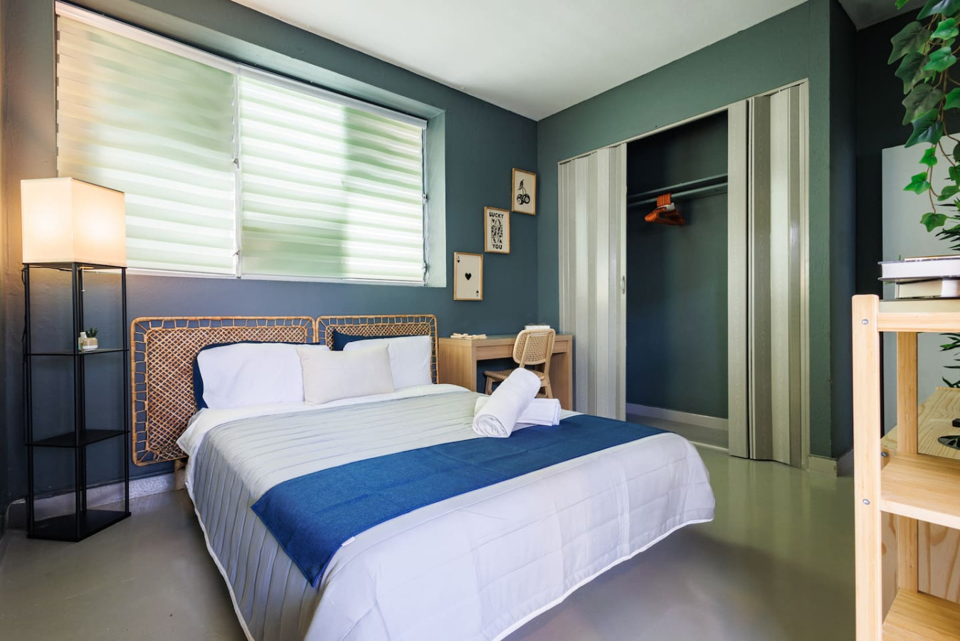Bedroom with a blue bedspread and white sheets (bedroom 2) — Spain Lagoon | San Juan | Private Patio, Santurce