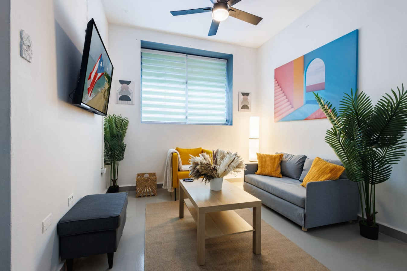 Living room with a couch, a table, and a ceiling fan — Spain Lagoon | San Juan | Private Patio, Santurce