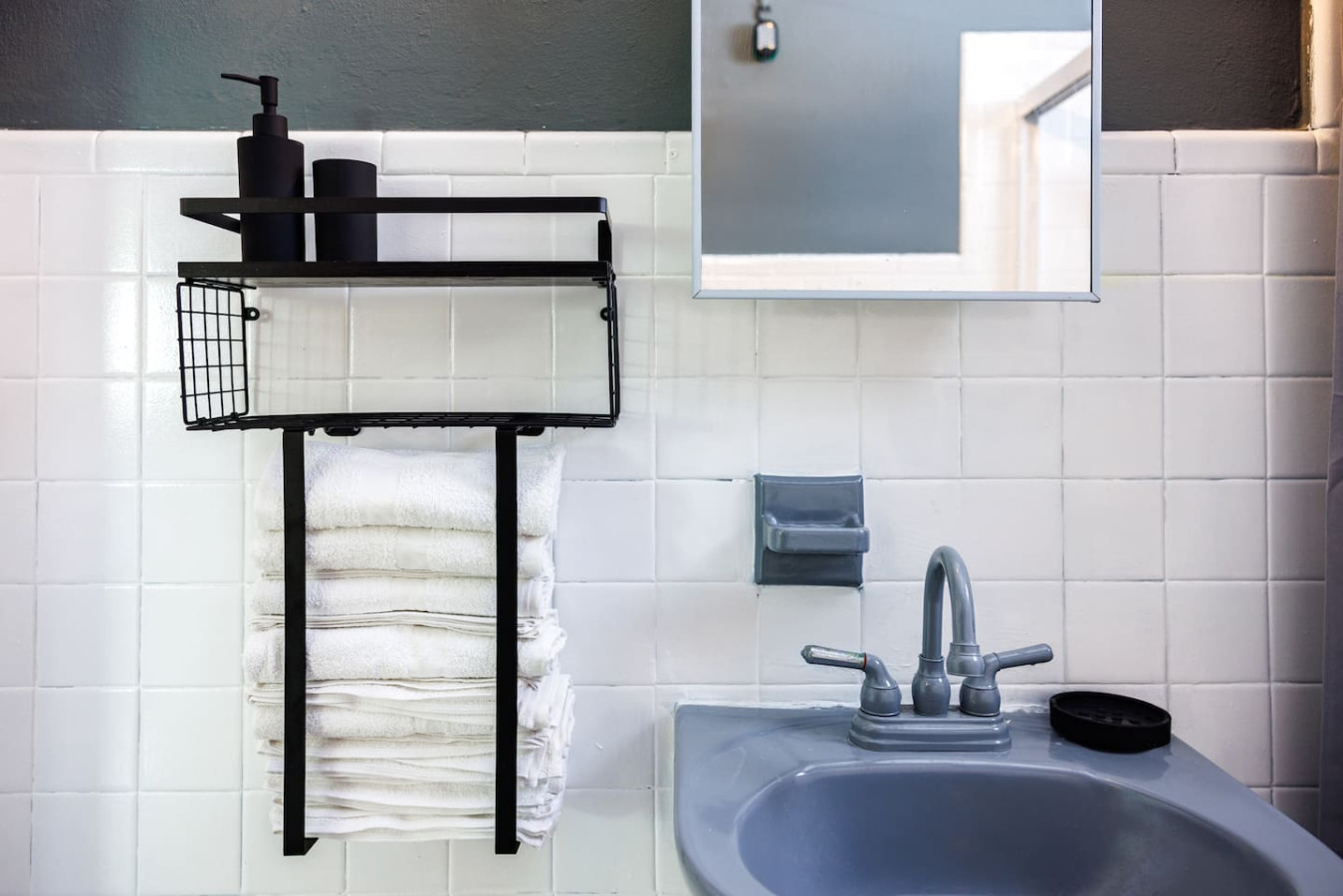 Bathroom sink with a towel rack and mirror — Spain Lagoon | San Juan | Private Patio, Santurce