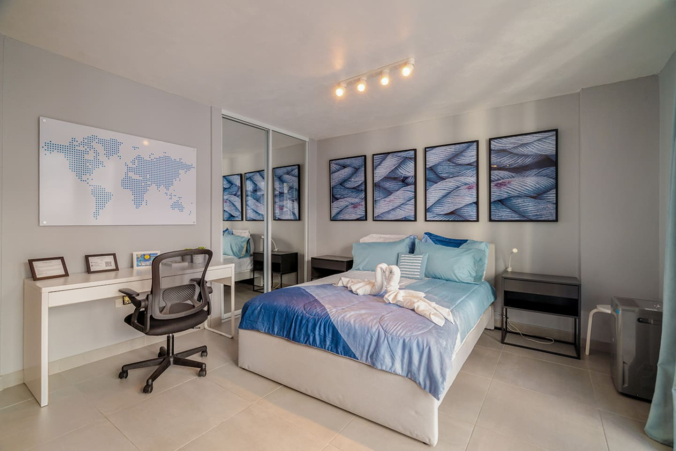 Bedroom with a blue bedspread and white pillows — OceanSide - Pool Balcony, Isla Verde