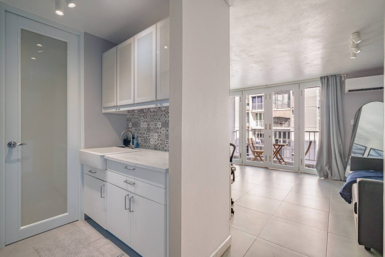 Kitchen with white cabinets and a sink — OceanSide - Pool Balcony, Isla Verde