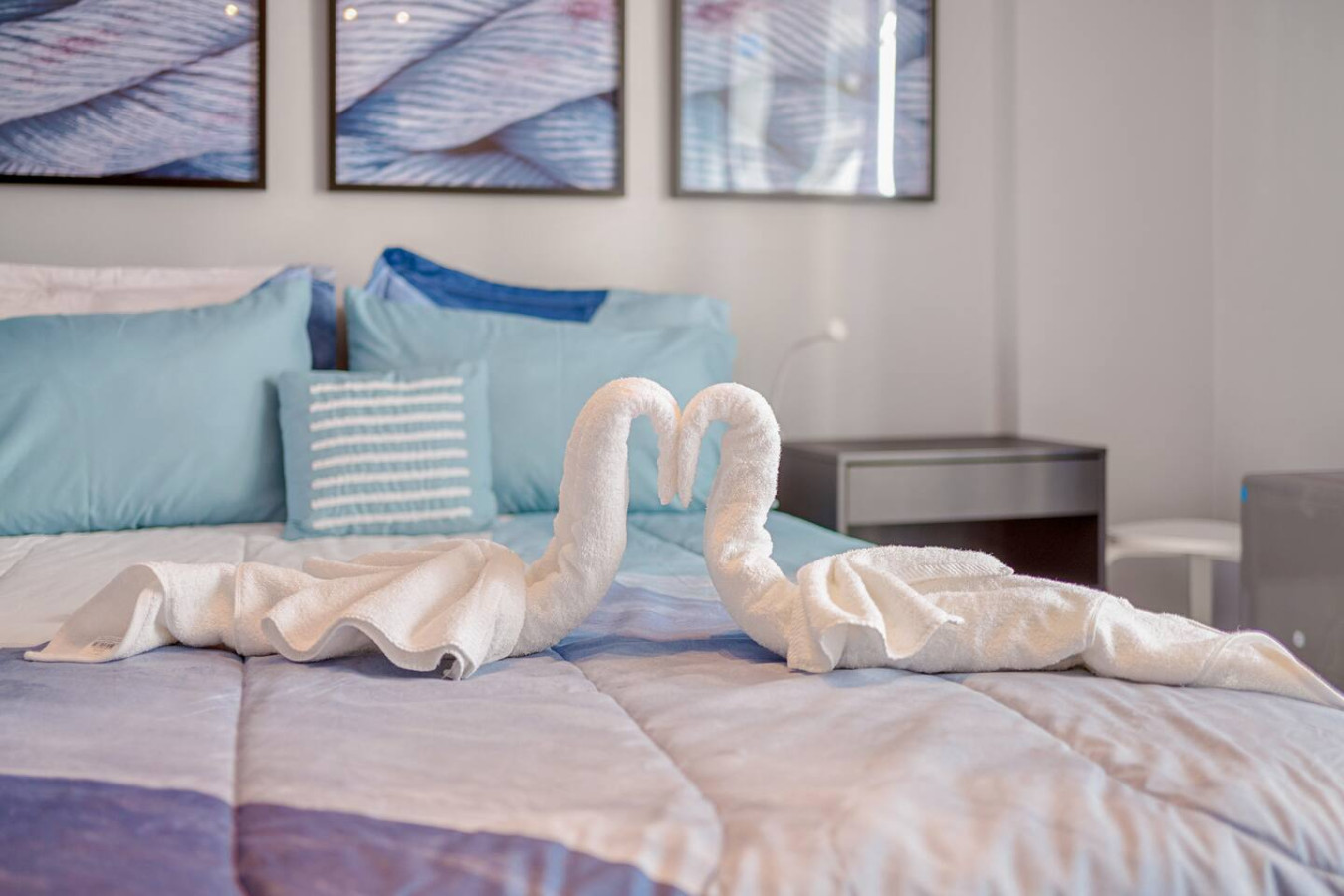 Two white towels arranged to look like a heart on a bed — OceanSide - Pool Balcony, Isla Verde