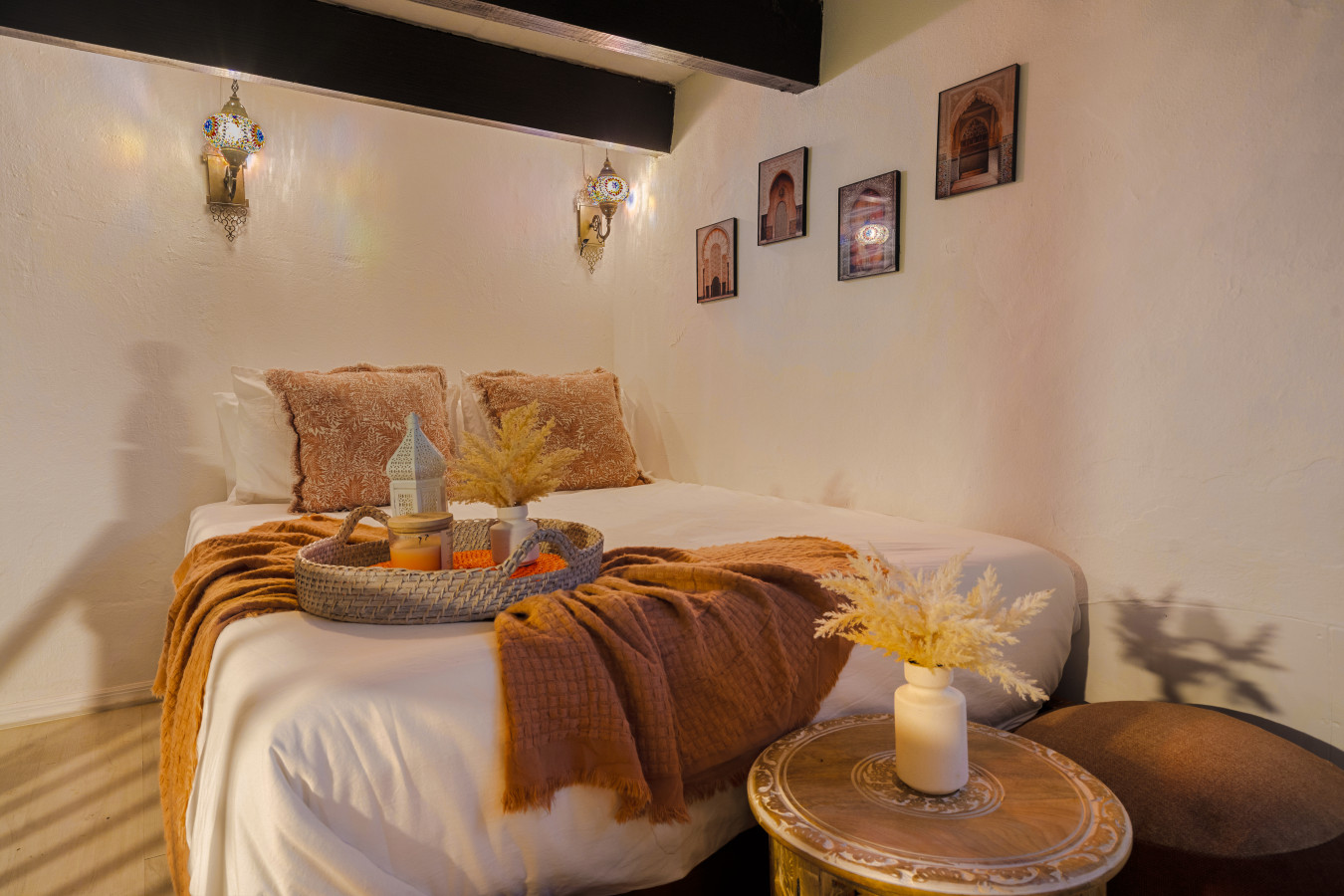 Bedroom with a bed, a table with a vase and candles, and a chair — Morocco Loft Sanjuanero | Viejo San Juan, Old San Juan