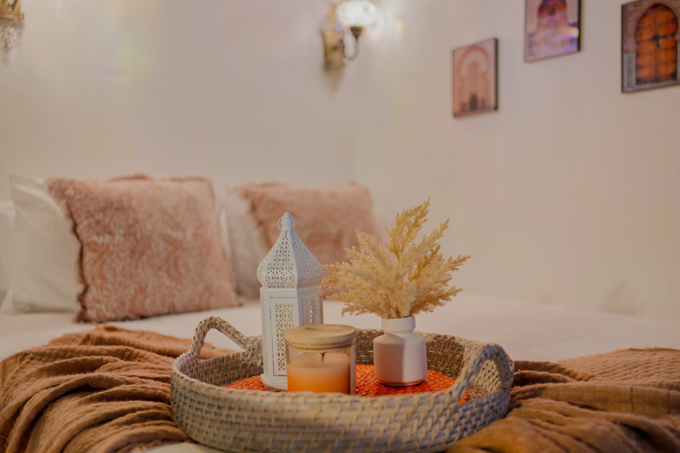 Bedroom with a bed and a table with a candle and a vase on it — Morocco Loft Sanjuanero | Viejo San Juan, Old San Juan
