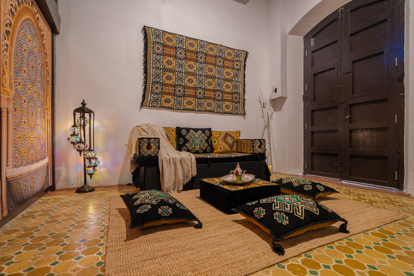 Living room with a black couch and a rug on the floor — Morocco Loft Sanjuanero | Viejo San Juan, Old San Juan