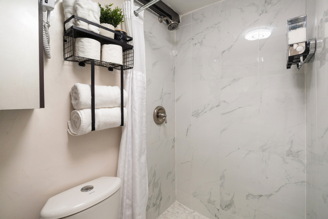 Bathroom shower with marble walls and a towel rack — Morocco Loft Sanjuanero | Viejo San Juan, Old San Juan