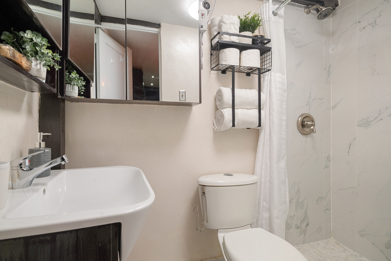 Bathroom with a marble-tiled shower and a toilet — Morocco Loft Sanjuanero | Viejo San Juan, Old San Juan