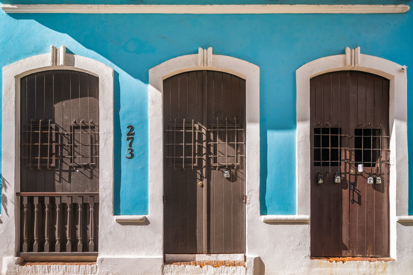 Blue facade with three arched wooden doors — Morocco Loft Sanjuanero | Viejo San Juan, Old San Juan