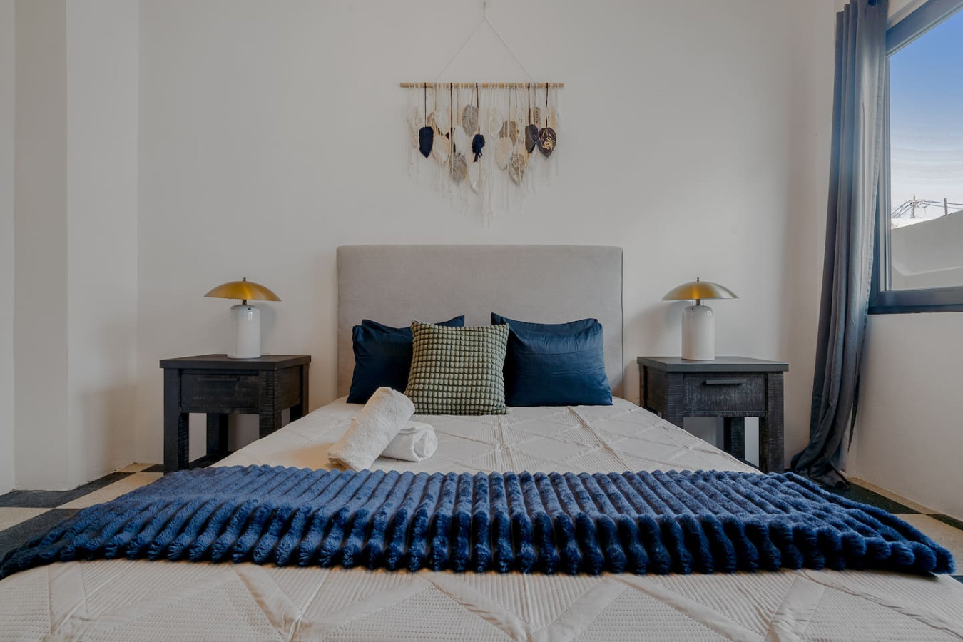 Bedroom with a blue blanket on the bed and a view of the ocean — Royal Palm Old San Juan, Old San Juan