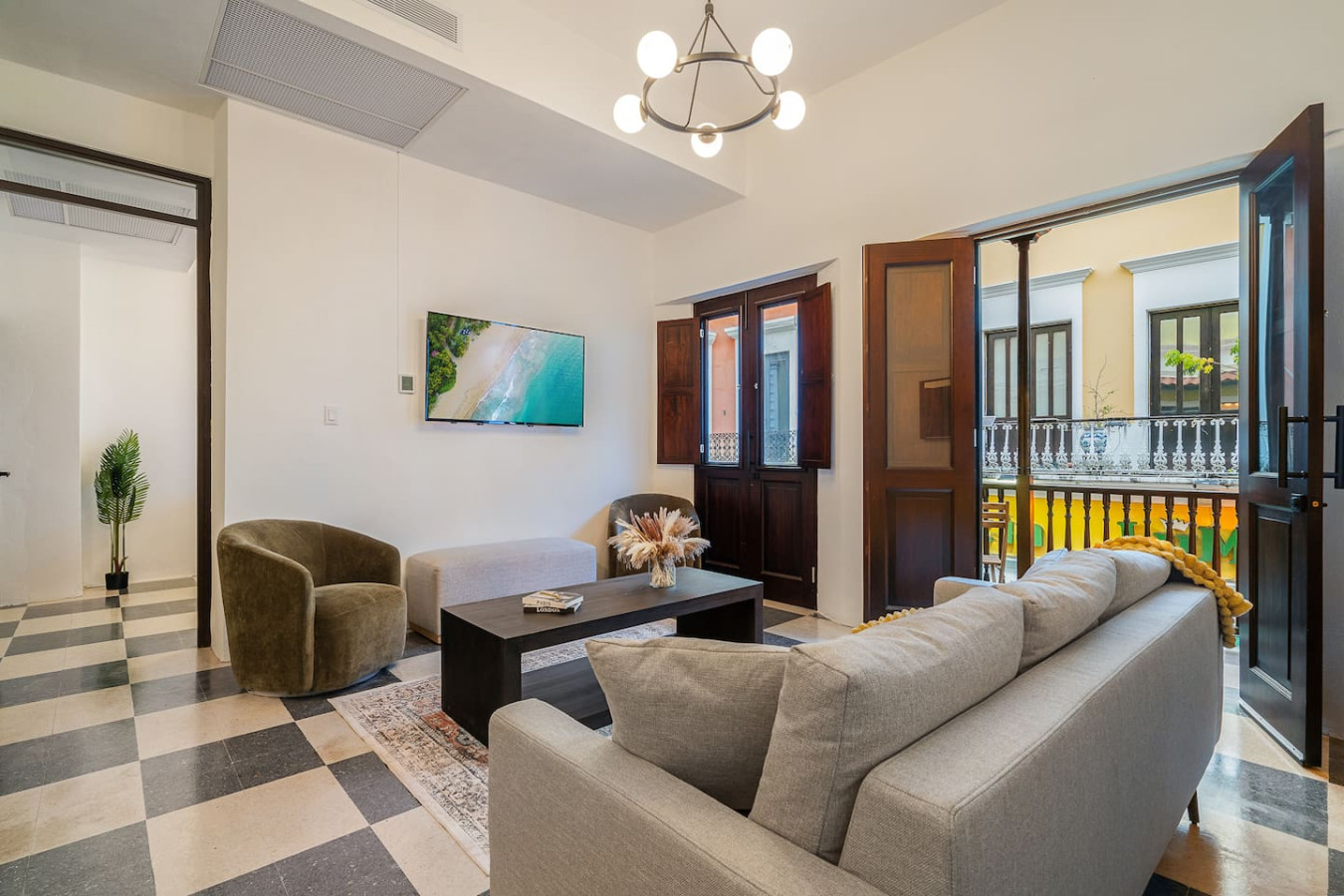 Living room with a flat screen TV and a couch — Soho House  The Grand Patio, Old San Juan