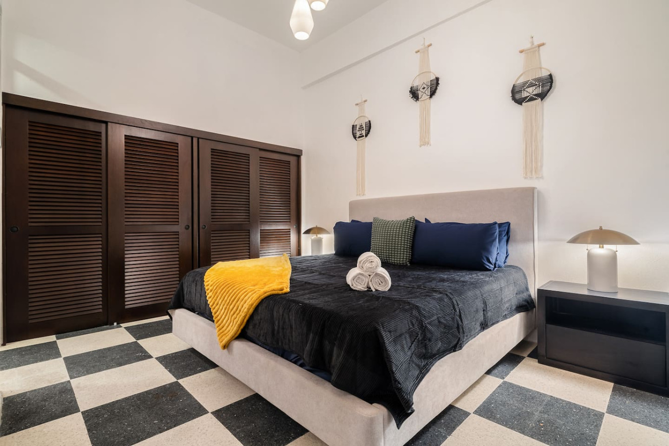 Bedroom with a bed and a yellow blanket on it — Soho House  The Grand Patio, Old San Juan