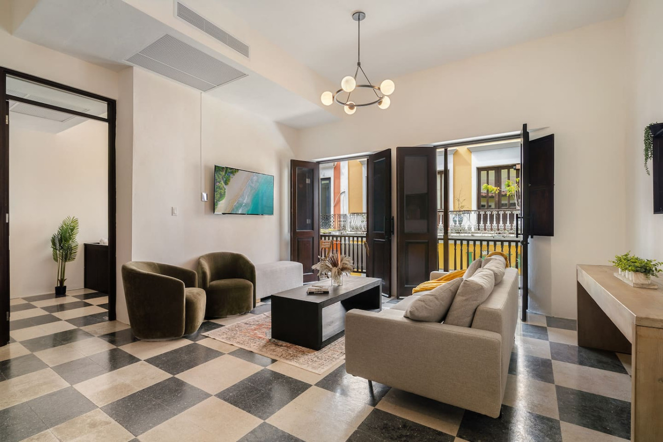 Living room with a couch, chair, and TV — Soho House  The Grand Patio, Old San Juan
