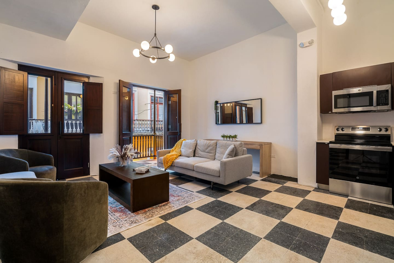 Living room with a couch, coffee table, and chairs — Soho House  The Grand Patio, Old San Juan