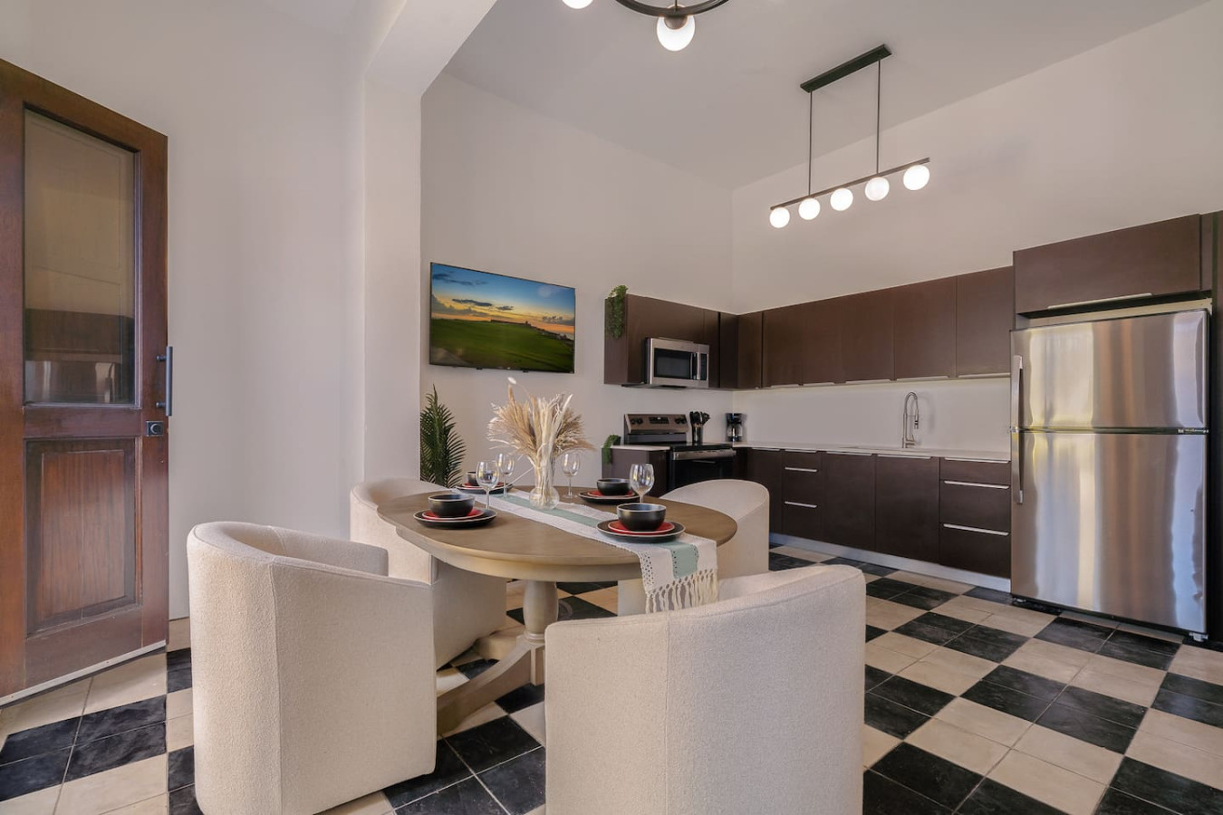 Dining room table with chairs and a microwave above it — Soho Garden Grand patio, Old San Juan