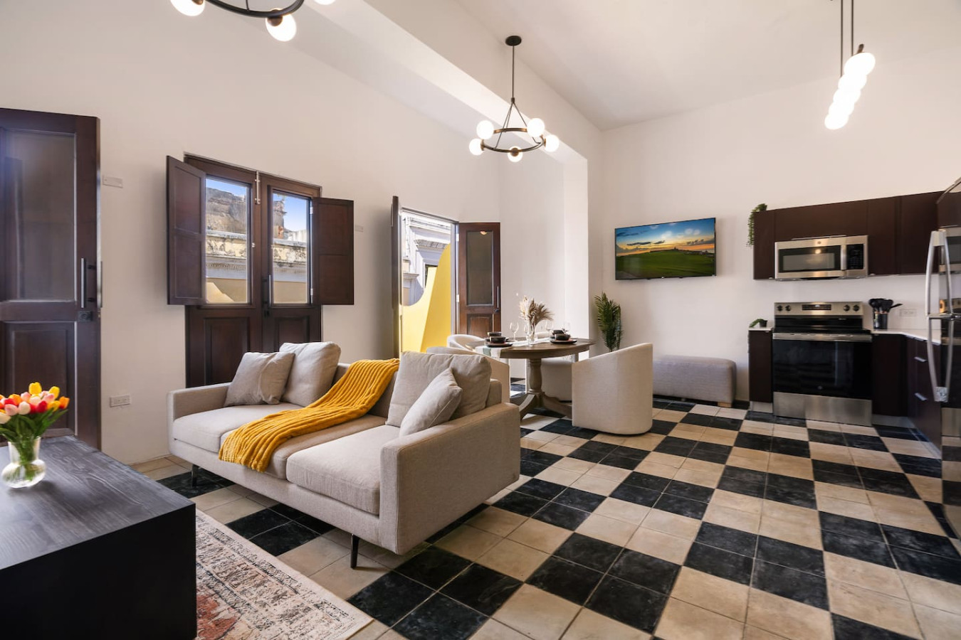 Living room with a couch and a yellow blanket on it — Soho Garden Grand patio, Old San Juan