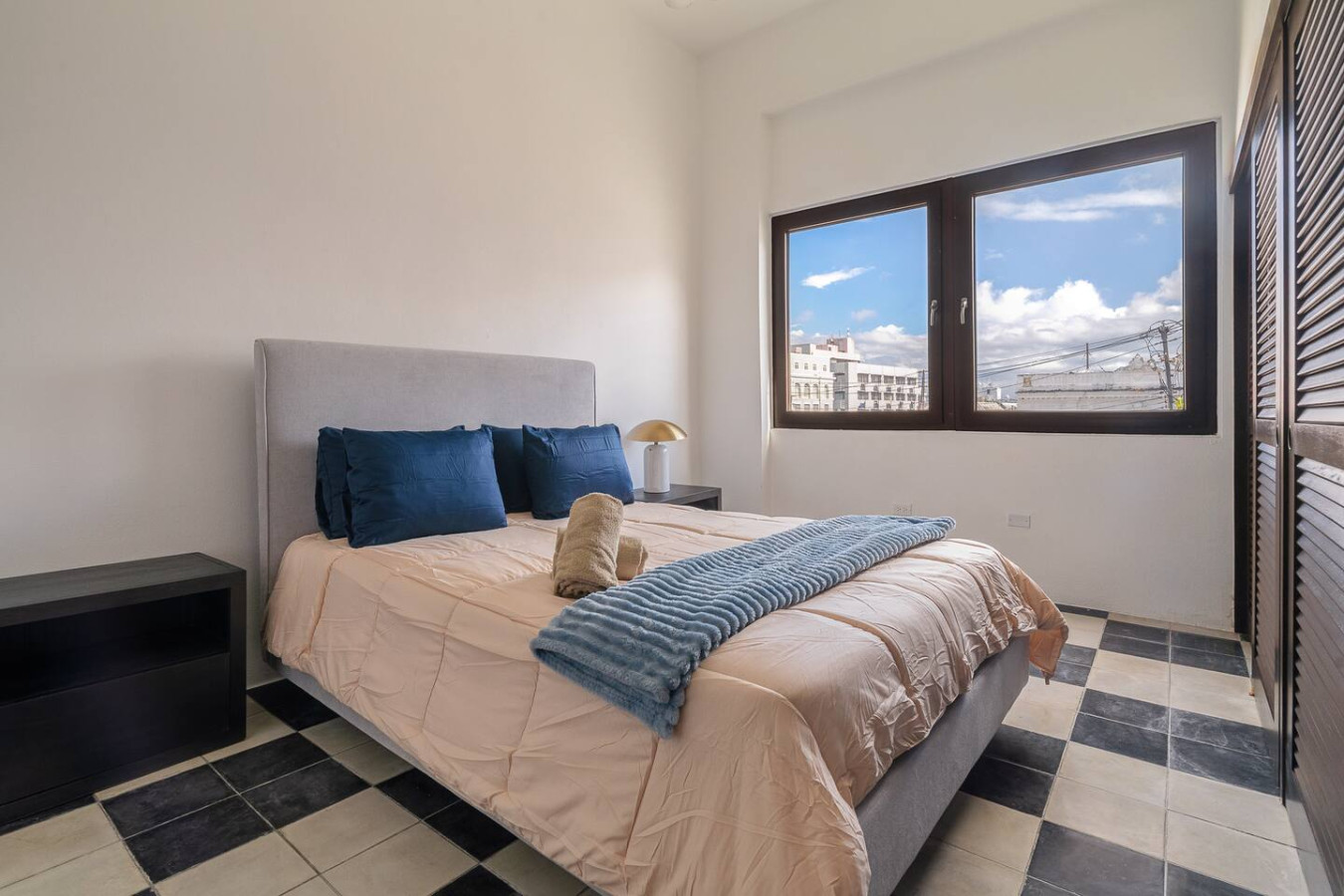 Bedroom with a bed and a window overlooking the city — Soho House – Inspired by RH, Old San Juan