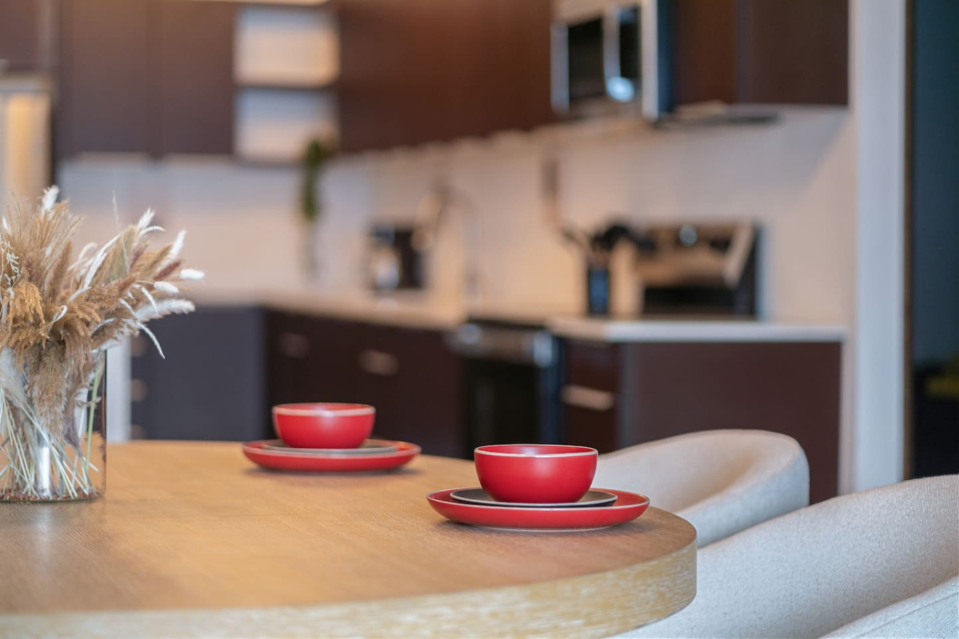 Wooden dining table with two red cups on it — Soho House – Inspired by RH, Old San Juan