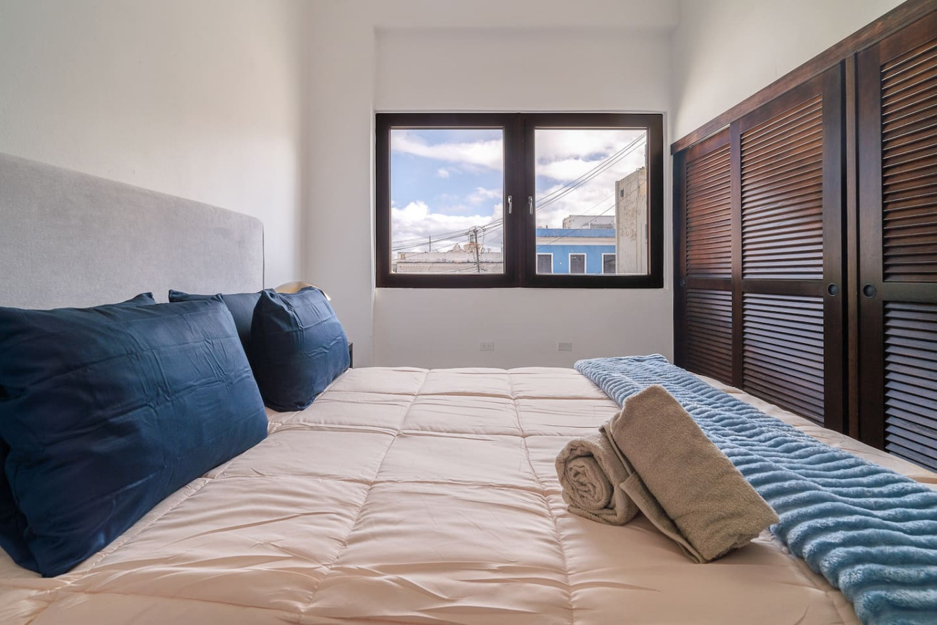 Bedroom with a white bed and blue pillows — Soho House – Inspired by RH, Old San Juan