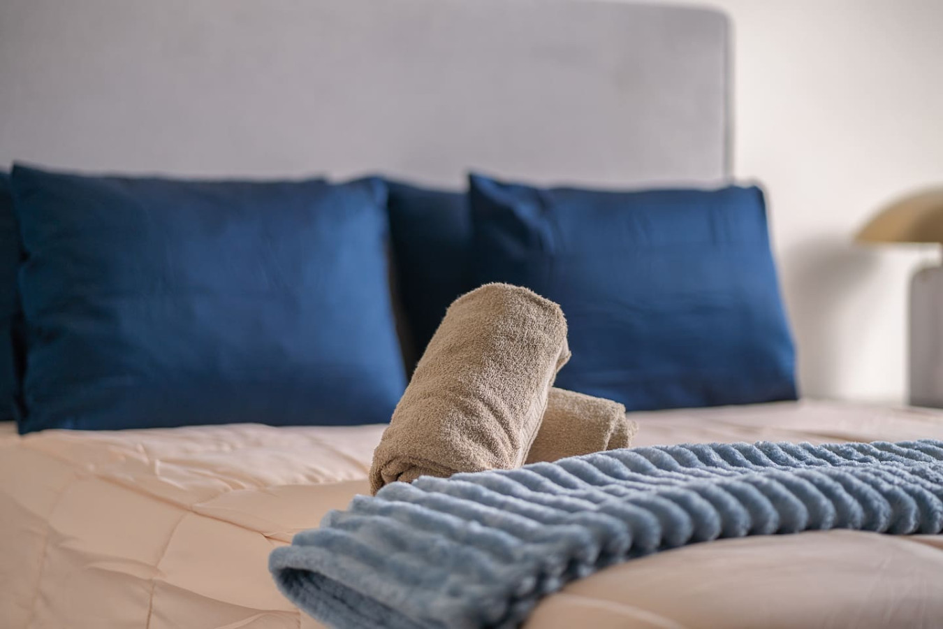 Bedroom with a white bedspread and blue pillows — Soho House – Inspired by RH, Old San Juan
