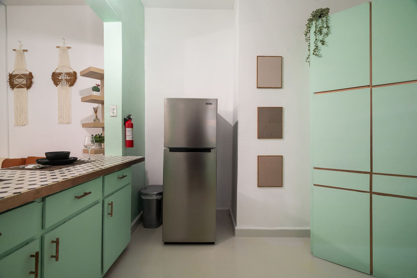 Kitchen with a stainless fridge and mint-green cabinets — Puerto House - Private Patio, Santurce