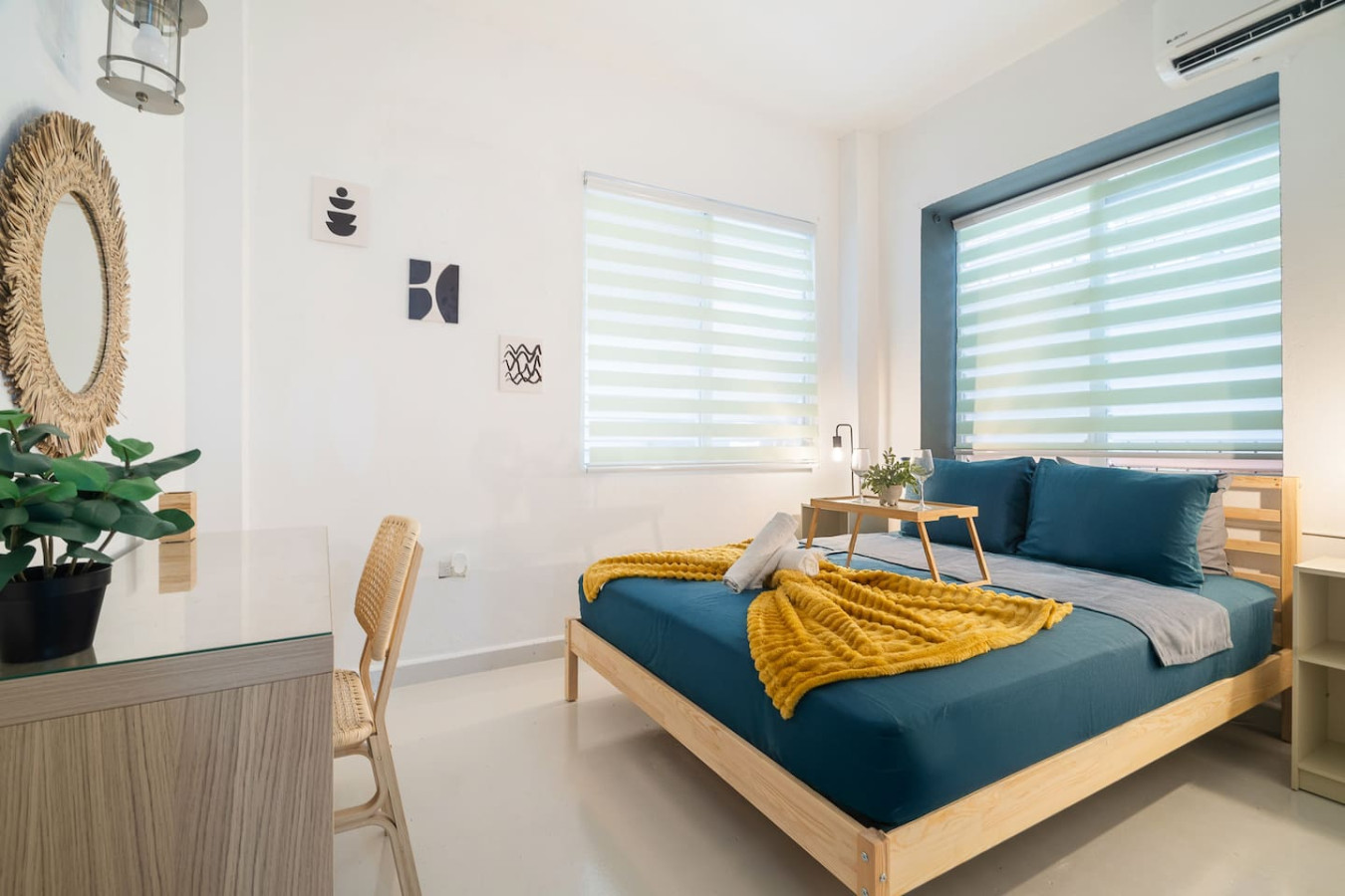 Bedroom with a blue bedspread and yellow throw blanket — Puerto House - Private Patio, Santurce