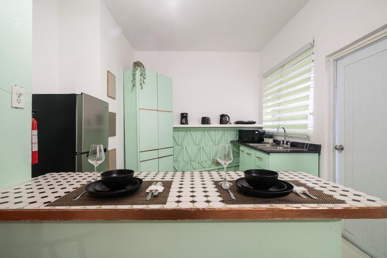 Kitchen with mint-green cabinets and a tiled breakfast bar — Puerto House - Private Patio, Santurce