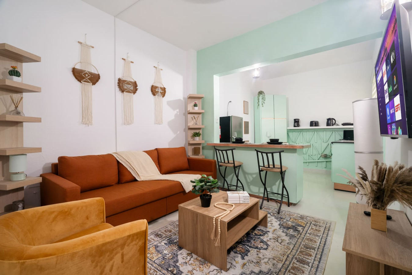 Living room with a couch, coffee table, and potted plant — Puerto House - Private Patio, Santurce