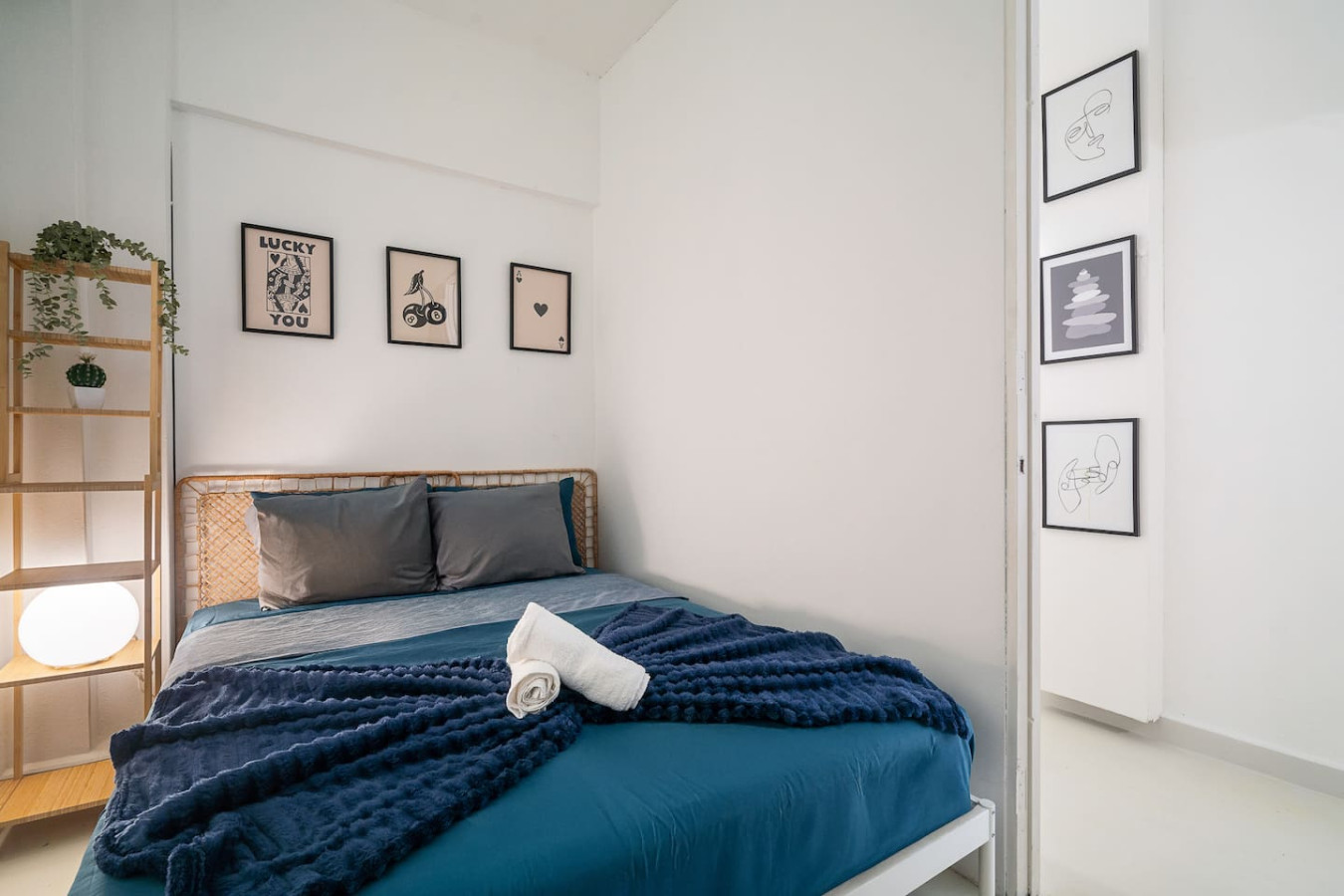 Bedroom with a blue bedspread and a white towel on it — Puerto House - Private Patio, Santurce