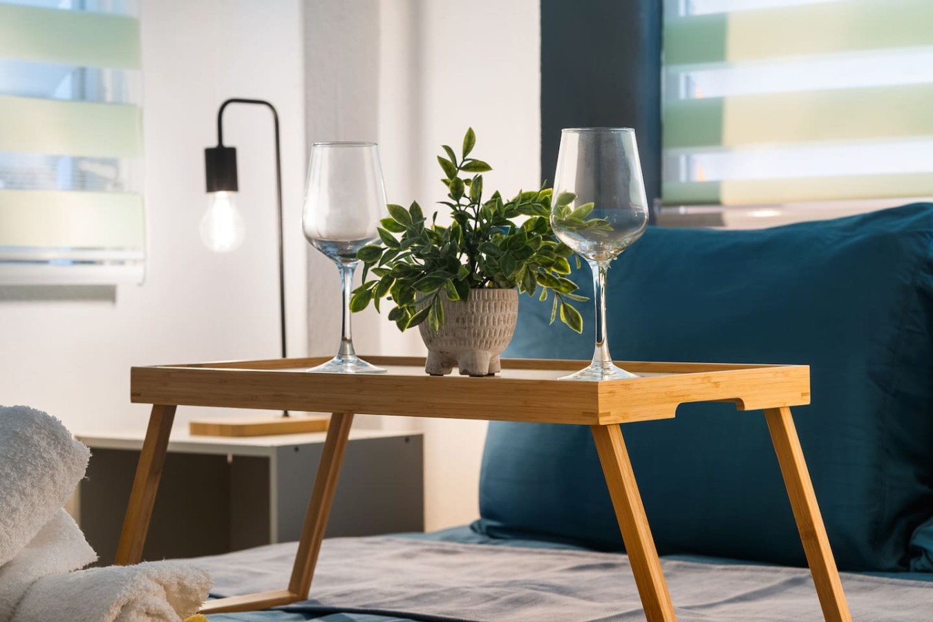 Bedroom with a table holding two wine glasses and a potted plant — Puerto House - Private Patio, Santurce