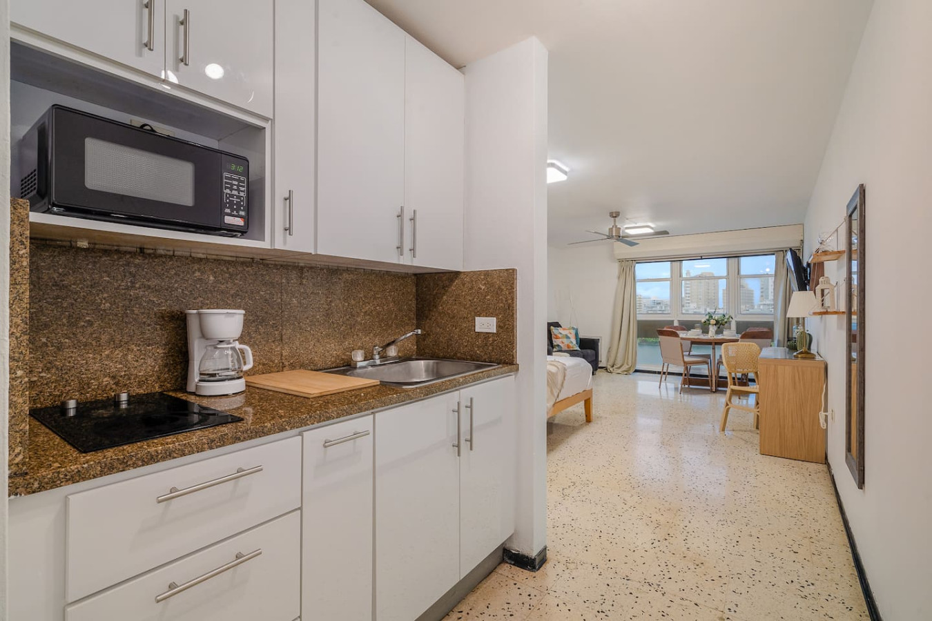 Kitchen with a microwave and a sink — Condado Penthouse